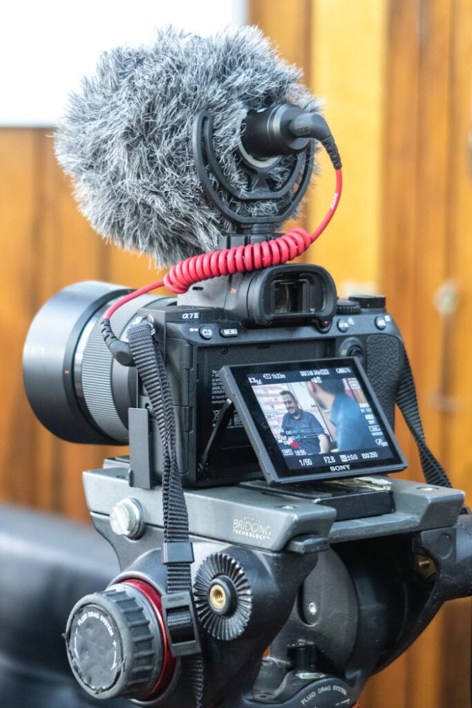Black Dslr Camera on Black Tripod Stand
